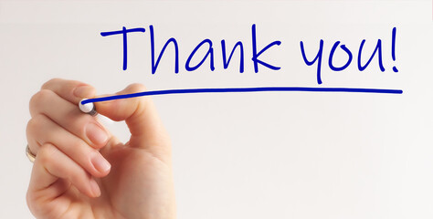 Hand writing Thank You with marker on transparent wipe board.