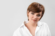 © Pixel-Shot - Young woman with beautiful short hair on grey background