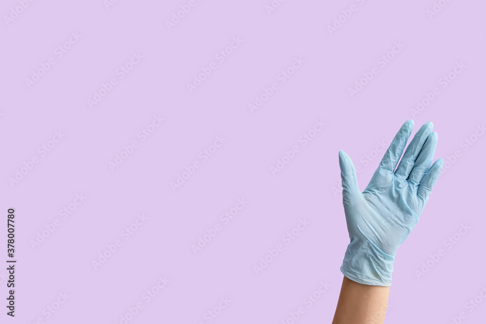 Gesturing hand in protective glove on color background