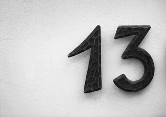 Wall Mural - iron Number 13 on white wall. Abstract background and texture for design.