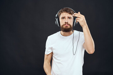 man in headphones with gamepad fun entertainment games lifestyle dark background