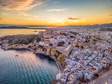 Aerial View Of Stunning Sunset Over Ibiza (Evissa) During A Winter Evening With View Of The Medieval Fortress And The Old Town