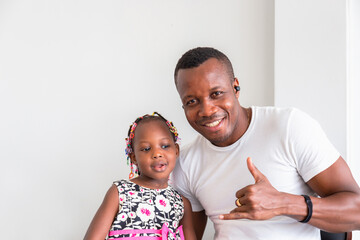 Wall Mural - Cheerful african american father and daughter playing in living room, Happiness family concepts