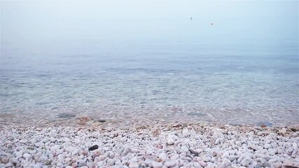 Wall Mural - Pebble beach and blue sky on background