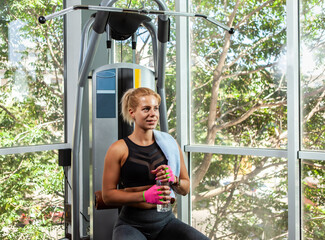 Wall Mural - Sport blond woman resting at gym. Healthy lifestyle