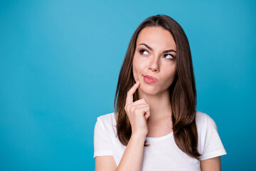 Poster - Closeup photo of attractive lady hold arm on chin look up side empty space thinking math theorem proof creative intelligent person wear casual white t-shirt isolated blue color background