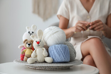 Crocheted toys and clews on table. Engaging in hobby