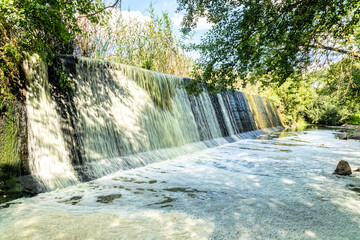 Poster - Picturesque old stone dam of an abandoned hydroelectric power station on the Mountain Tikich river in Buky village, Ukraine. Picturesque rural landscape and fresh stream of running stormy water