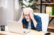 © Vadim Pastuh - Senior man looks at the laptop screen with shock and surprise, he holding head in his hands