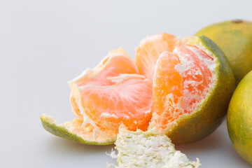 Sticker - Closeup shot of a peeled tangerine on a gray background