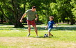 © Syda Productions - family, fatherhood and people concept - happy father and little son with ball playing soccer at summer park