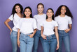 © Prostock-studio - Group Of Happy Mixed Women Hugging Standing Over Purple Background