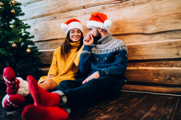 Wall Mural - Beautiful young lovers having romantic moment during Christmas