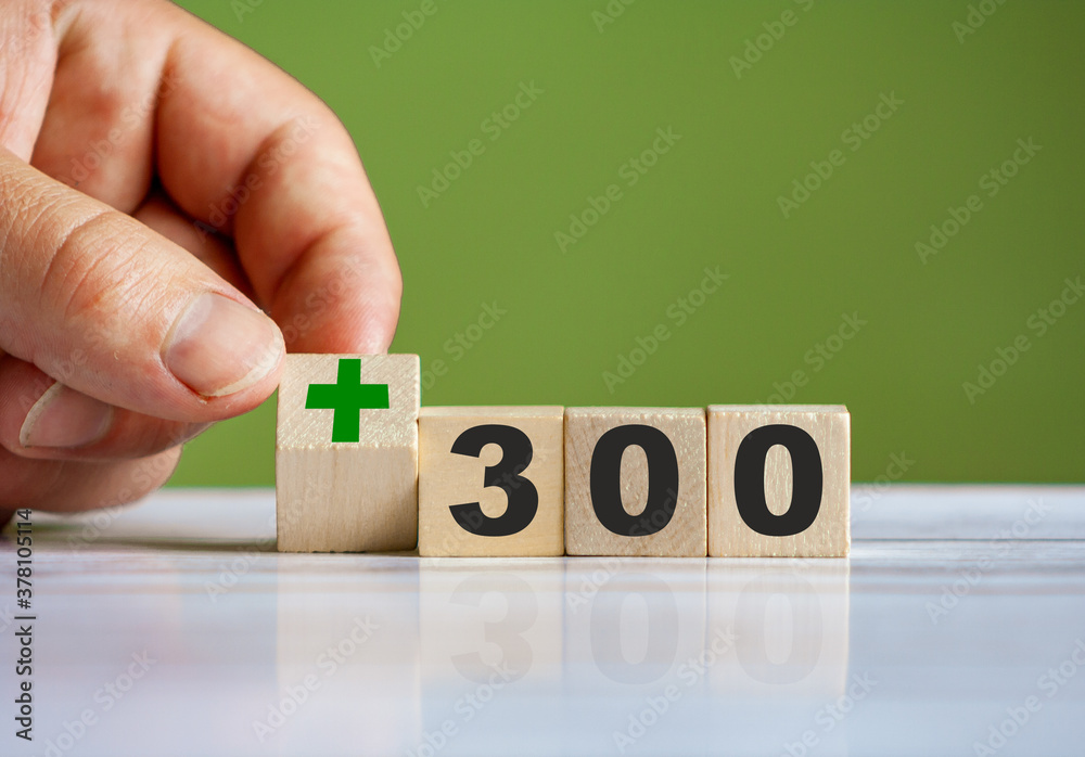 hand turn wooden block with plus sign and set text "+300" - obrazy, fototapety, plakaty 