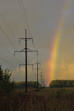 A Bright Rainbow Over A High-voltage Power Line After An Autumn Rain At Sunset. Autumn Bad Weather In The Foothills Of The Western Urals.