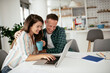 © JustLife - Husband and wife preparing bills to pay. Young couple having financial problems...