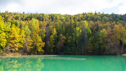 Wall Mural - Blue mountain lake in autumn. Beautiful autumn morning