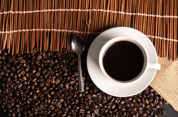 warm cup of coffee on brown background