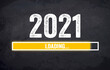 Black chalkboard with yellow loading bar and message Loading 2021