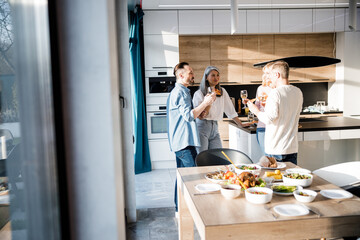 Wall Mural - Happy mature friends celebrating together at home