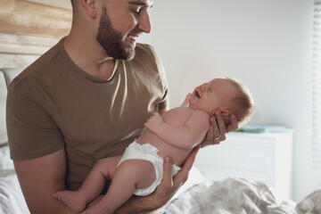 Canvas Print - Father with his newborn son at home