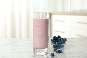 Poster - Tasty milk shake and blueberries on white marble table