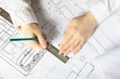 © yta - The concept of architecture. An architectural engineer holds a pencil and ruler over the blueprints