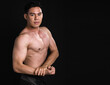 © Ann Rodchua - Portrait of asian muscular man standing on black background