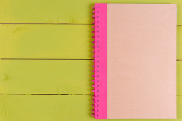 Notebook paper with on wooden background.