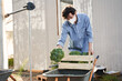 © Yakobchuk Olena - Young man gathering harvest of broccoli on farm
