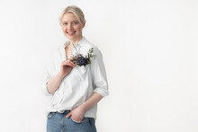 Cheerful Young Woman Touching Flowers In Her Pocket