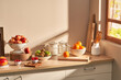 © 365mm/Stocksy - Ripe fruits on kitchen cupboard