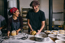 Cheerful Bakery Workers Making Bread And Talking