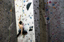 Rock Climber High On An Indoor Climbing Wall