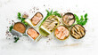 Canned fish in tin cans: Salmon, tuna, mackerel and sprats. Top view. Free space for your text.