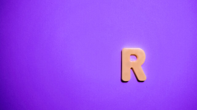 letter of the anguilla alphabet on a pink background