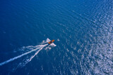 Fototapeta Nowy Jork - Boat drone photo. Vintage wooden boat in sea. Speed boat at sea, view from above.