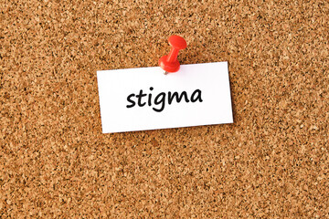 Wall Mural - Stigma. Word written on a piece of paper, cork board background.