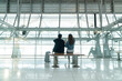 © whyframeshot - Safety travel new normal lifestyle asian friend couple relax sit wait for time schedule to aboard departure,asian male and female wearing protective face mask in airport terminal