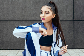 teenage female in sportswear sit outdoor after yoga exercise relaxing and resting while having a break   look to site and enjoy after workout in urban city