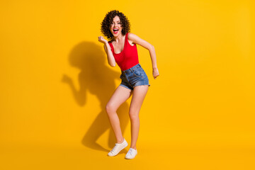 Wall Mural - Full length body size view of her she nice attractive lovely glamorous cheerful cheery funky wavy-haired girl dancing night club having fun isolated bright vivid shine vibrant yellow color background