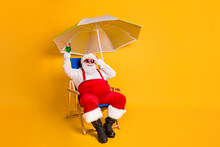 Full Size Photo Of White Grey Hair Bearded Santa Claus Sit Chaise-lounge Raise Alcohol Glass X-mas Christmas Eve Noel Time Relax Wear Hat Pants Isolated Bright Shine Color Background