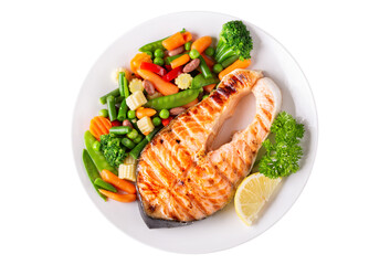 Wall Mural - plate of grilled salmon steak with vegetables isolated on a white background