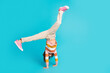© deagreez - Full length body size view of her she nice attractive sporty talented girl dancing break free time leisure standing on hands isolated over bright vivid shine vibrant blue color background
