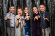 © Syda Productions - celebration, people and holiday style concept - happy friends in party clothes with tinsel fringe curtain over black background