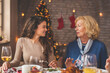 © Impact Photography - Mother and daughter having conversation at Christmas dinner
