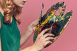 © SHOTPRIME STUDIO - Woman artist green dress easel eat drawing art pink background