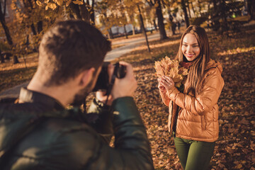 Sticker - Photo of young guy taking photo digital camera his beautiful girl hold maple leaves in fall september town park