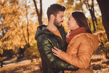 Poster - Photo of bonding couple guy embrace cuddle his girlfriend in outside autumn town park wear season coat