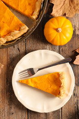 Wall Mural - traditional pumpkin pie on wood background